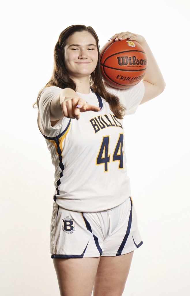 Megan Yarnevich, Bullis High School Student, holding a basketball over her shoulder.