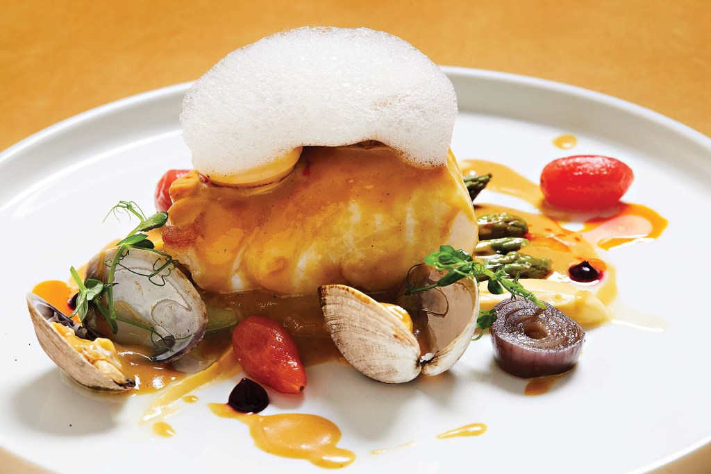 a fancy dish with sauces and foam